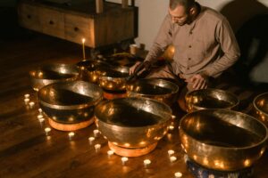 A man using sound bowl to create vibrational sound